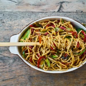 Tasty stir-fried noodles with fresh vegetables and sesame seeds, perfect for a healthy meal.